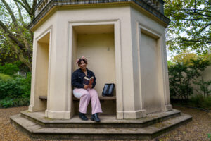 A girl sitting down with a book in her hand