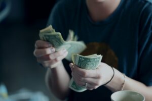 A person counting dollars