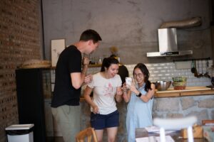 three people happily looking at their phone