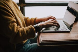 A person typing on the computer