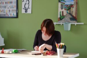 A woman looking down at her books