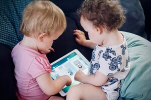 two babies sharing an iPad