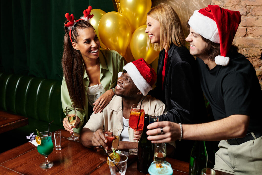 Friends and colleagues share laughter and cocktails at a joyful corporate celebration.