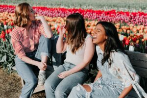 A group of friends laughing in a field