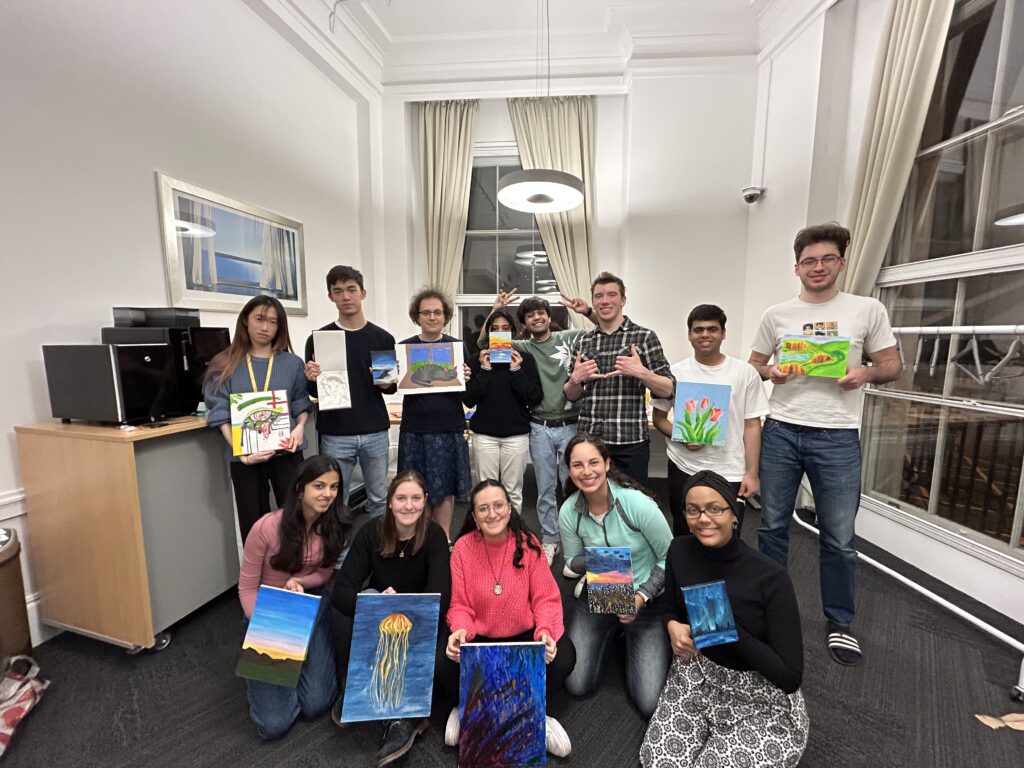 A group of students with their art pieces