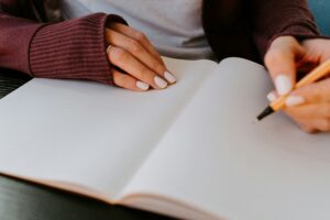 A person writing in a note book