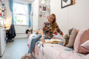 A girl sitting on her bed