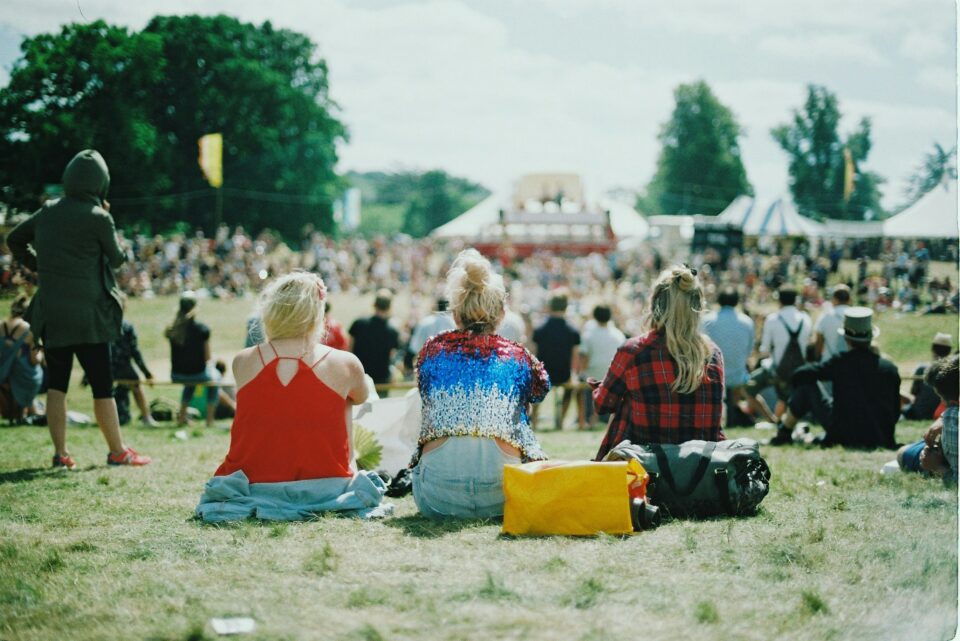 A group of women facing towards a stage