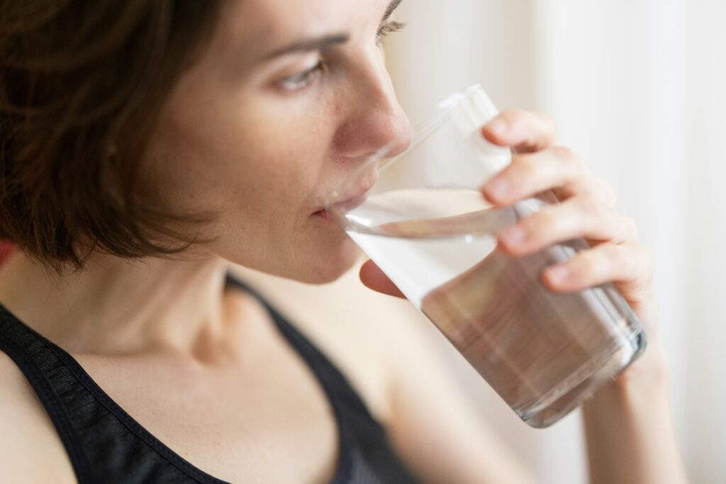 A woman drinking a cup of water 