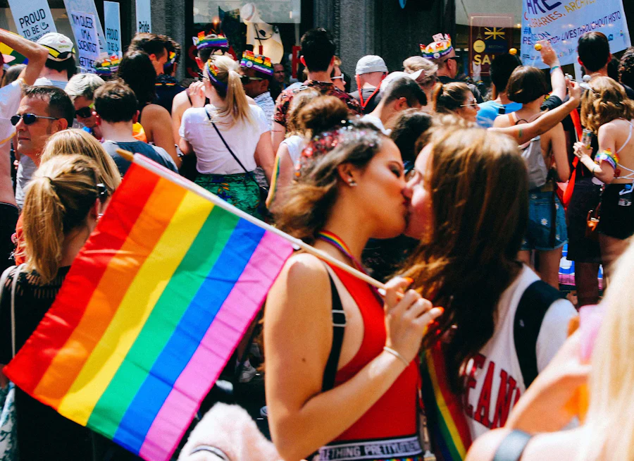 A group of people at the pride parade in colourful colours. 