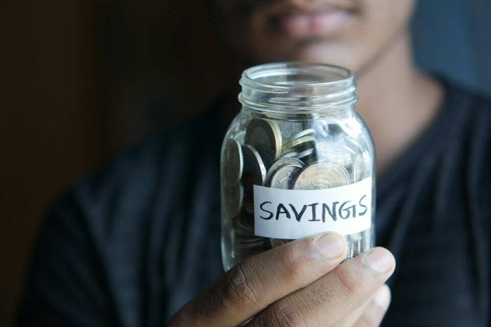 A person holding a money jar