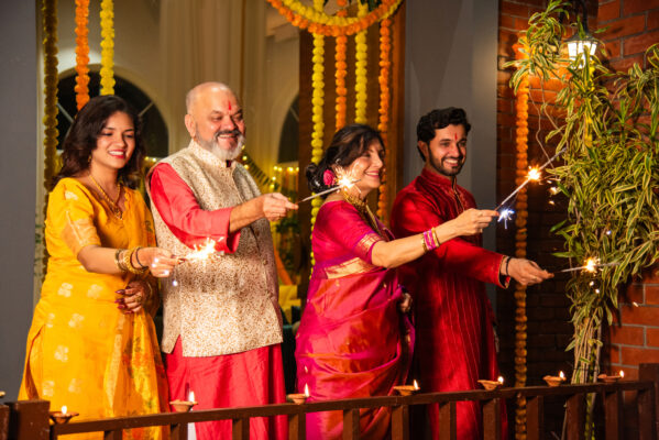 A family are lighting sparklers to celebrate Diwali.