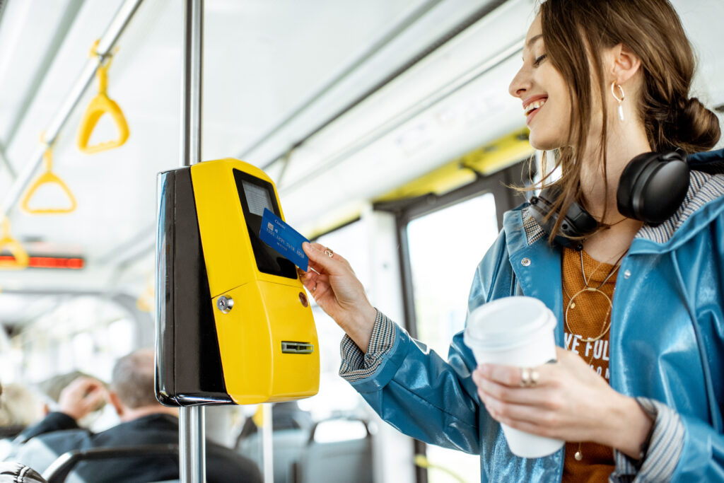 Women smiling using her phone to pay for public transport