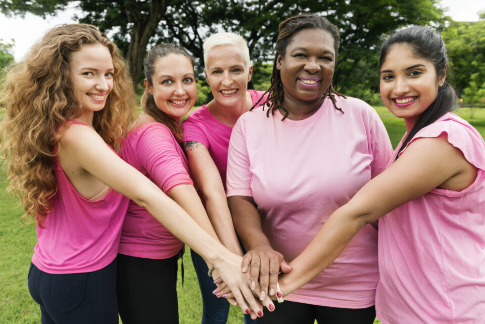 women joining hands in the middle