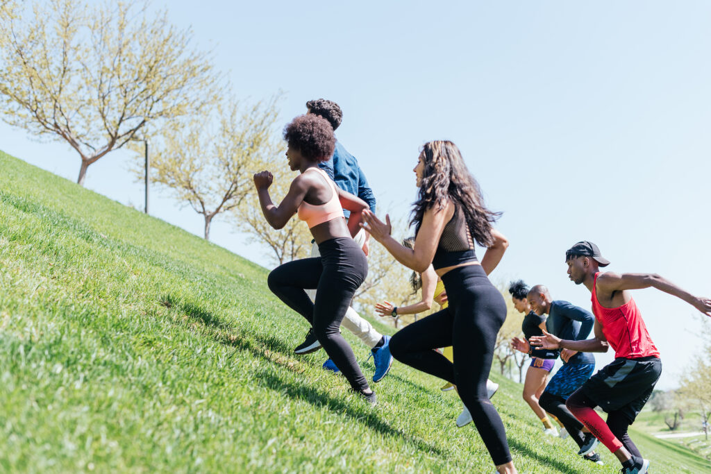 Group of runners running up a hill. 