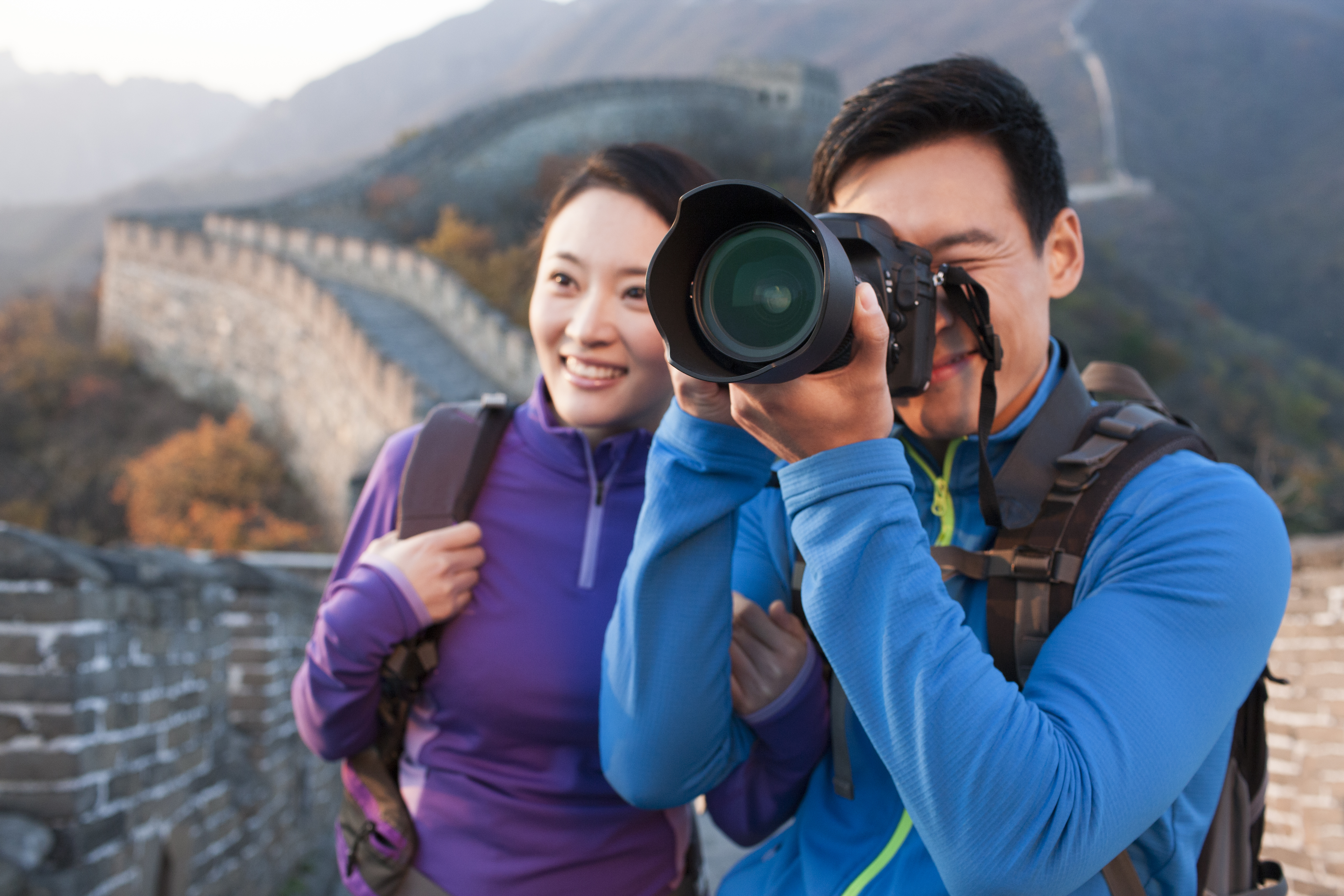 Young Chinese couple photographing on Great Wall